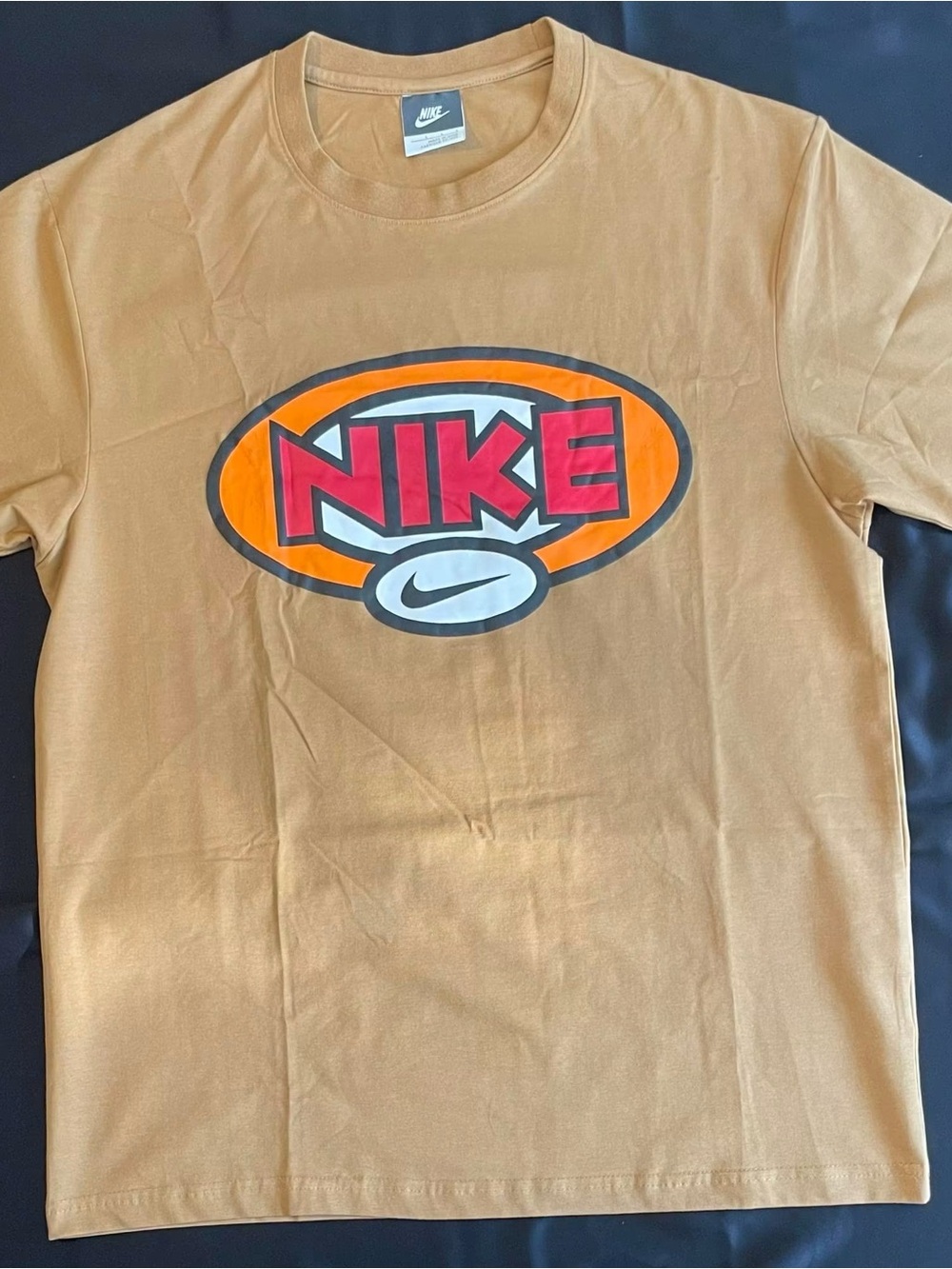 Nike Tan Tee with Orange Oval and Red Logo